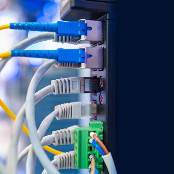 Close-up of a network's wires connected to the power supply.
