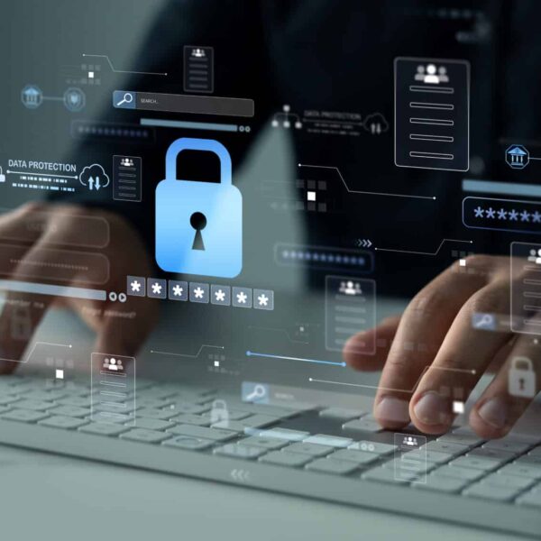 Hands typing on a keyboard with digital security icons, such as a padlock and data symbols, overlaid to show cybersecurity.